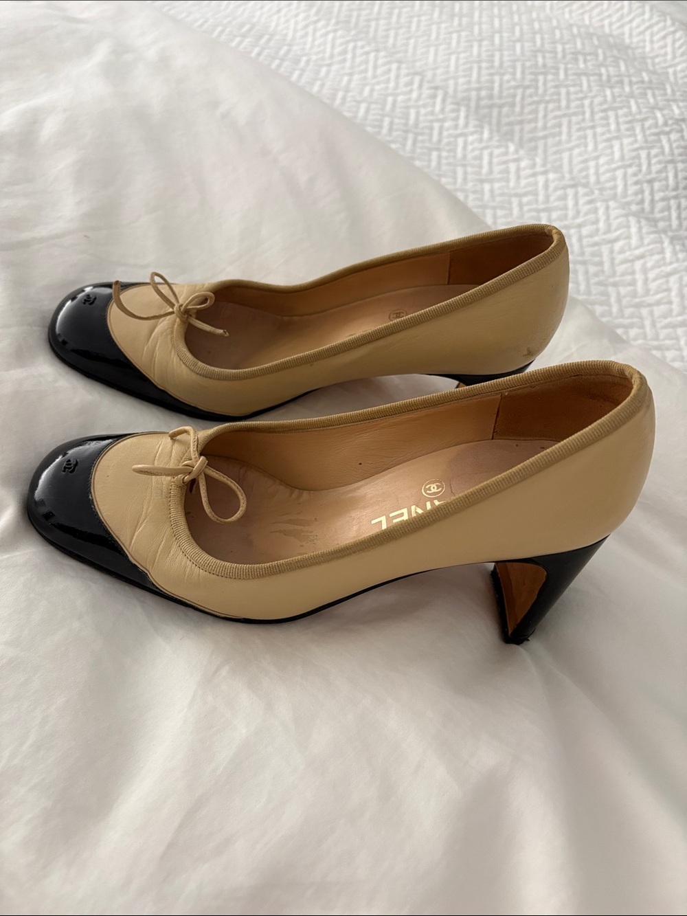 CHANEL Beige and Black Cap-Toe Bow Mid-Heel Pumps